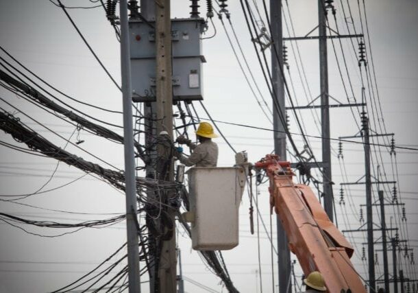 Electricians Wiring Cable repair services.
Technician checking fixing broken electric wire on pole.
Electricity power utility worker in crane truck bucket fixes high voltage power transmission line.