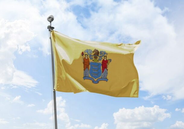 New Jersey USA State Waving Flag Against Cloudy Sky Background