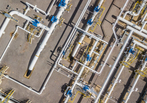 Aerial top view natural gas pipeline, gas industry, gas transport system, stop valves and appliances for gas pumping station.