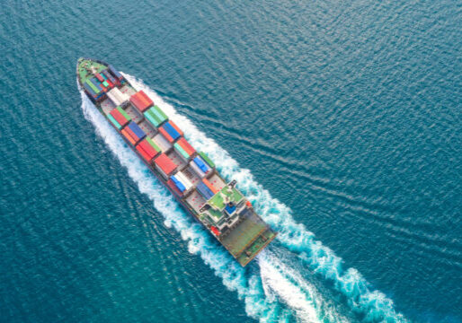 Container ship in export and import business logistics and transportation. Cargo and container box shipping to harbor by crane. Water transport International. Aerial view and top view.