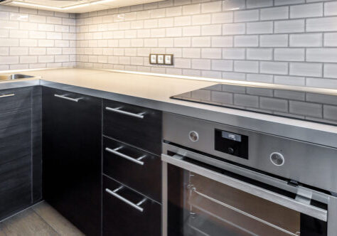 Interior Of Kitchen With Lighting. Modern Kitchen With Electric Interior of kitchen with lighting. Modern kitchen with electric stove and oven. Black induction cooker in the kitchen.