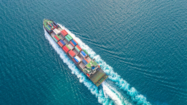 Container ship in export and import business logistics and transportation. Cargo and container box shipping to harbor by crane. Water transport International. Aerial view and top view.