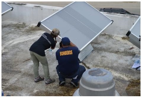 Workers install new solar panels on a building in Puerto Rico after Hurricane Maria. Photo courtesy of Empowered by Light.